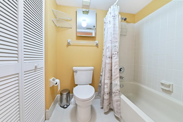 bathroom featuring tile patterned floors, toilet, and shower / tub combo