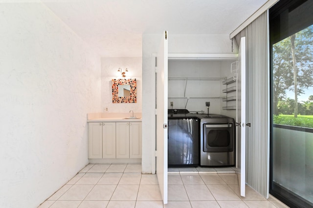 9170 SW 14th St Unit 4107, Boca Raton, FL 33428 - washroom featuring laundry area, independent washer and dryer, a sink, light tile patterned floors, and a textured wall