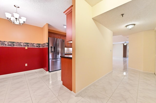 9170 SW 14th St Unit 4107, Boca Raton, FL 33428 - hall featuring baseboards, marble finish floor, a textured ceiling, and a chandelier