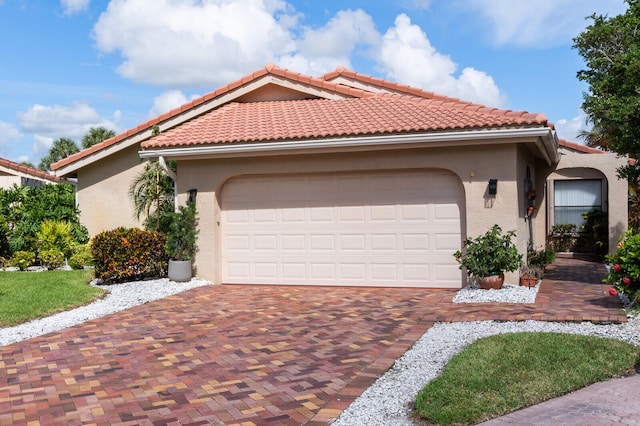 mediterranean / spanish house featuring a garage