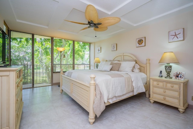 tiled bedroom featuring ceiling fan and a wall of windows