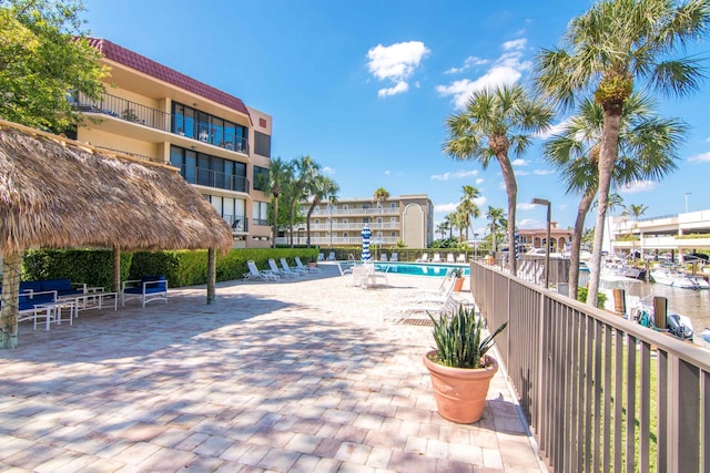 view of property's community featuring a water view and a pool