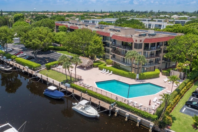 view of pool with a water view and a patio