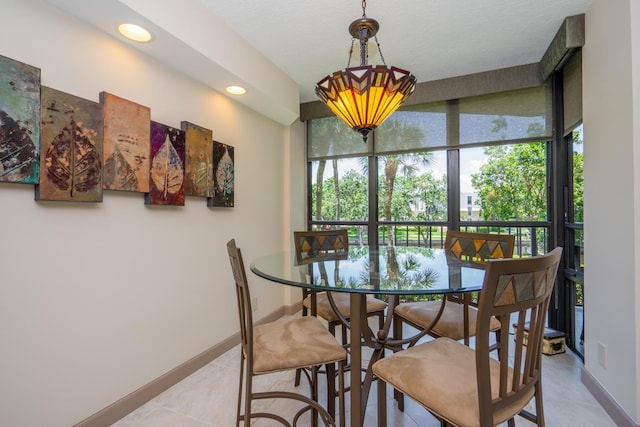 dining space with an inviting chandelier and light tile patterned flooring