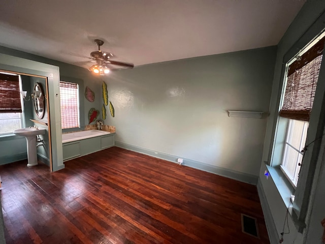 unfurnished bedroom with a closet, dark hardwood / wood-style floors, and ceiling fan