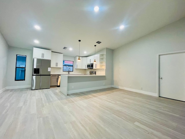 kitchen featuring light hardwood / wood-style floors, hanging light fixtures, stainless steel appliances, sink, and white cabinetry