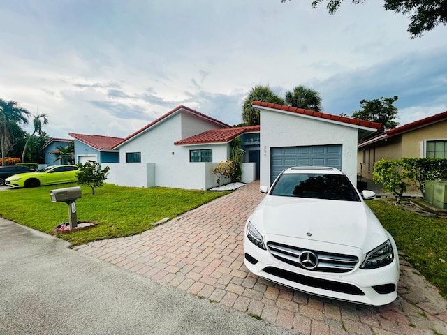 view of front facade with a garage and a front lawn