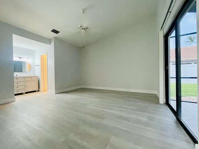 unfurnished bedroom with multiple windows and hardwood / wood-style floors