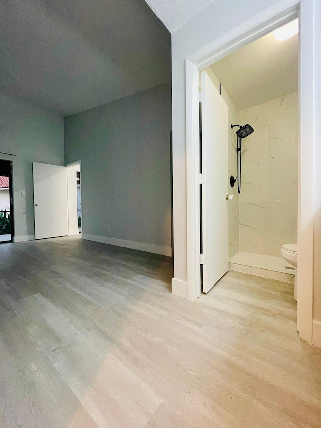 additional living space with a textured ceiling and light hardwood / wood-style flooring