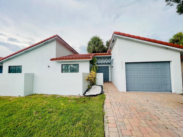 view of front of property with a front yard and a garage