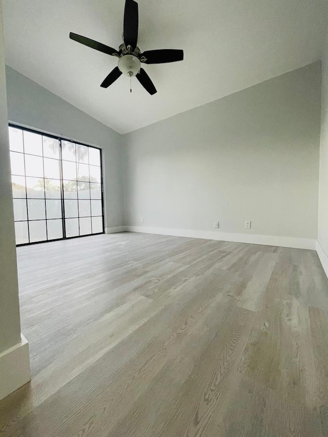 unfurnished room with ceiling fan and vaulted ceiling