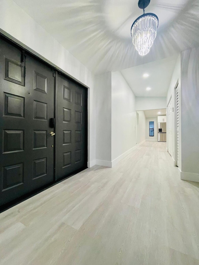 entryway with a notable chandelier and carpet floors