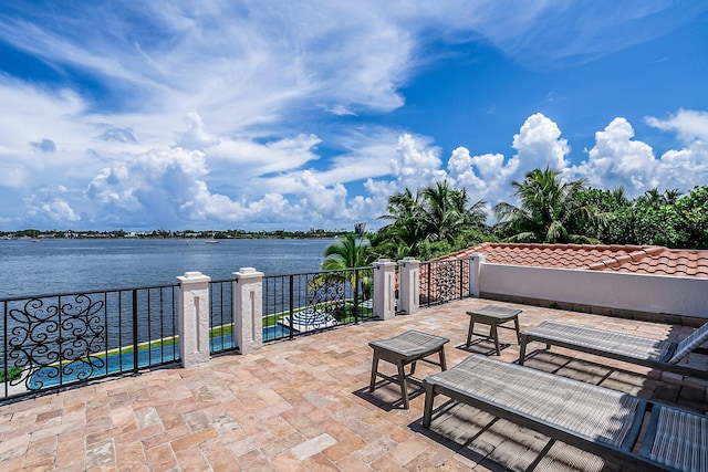 view of patio with a water view