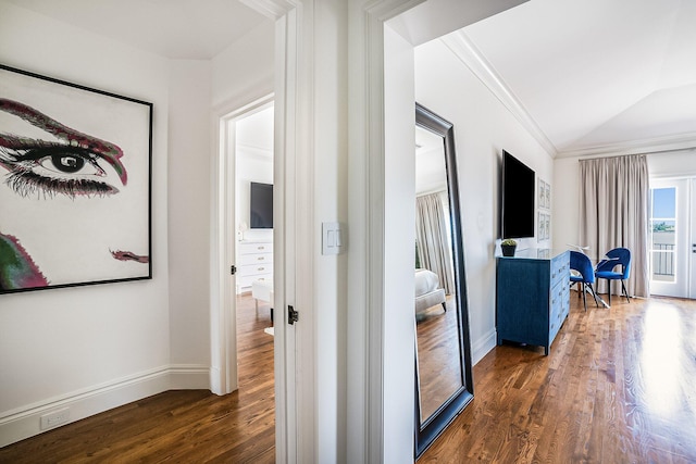 hall with lofted ceiling, crown molding, and dark hardwood / wood-style floors