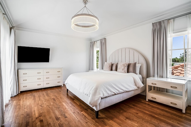 bedroom featuring ornamental molding and dark hardwood / wood-style flooring