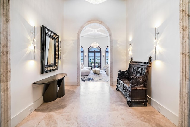 foyer with coffered ceiling and a high ceiling