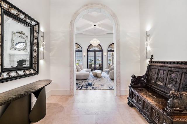 foyer featuring french doors, coffered ceiling, and beam ceiling