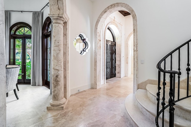 foyer entrance with decorative columns and french doors