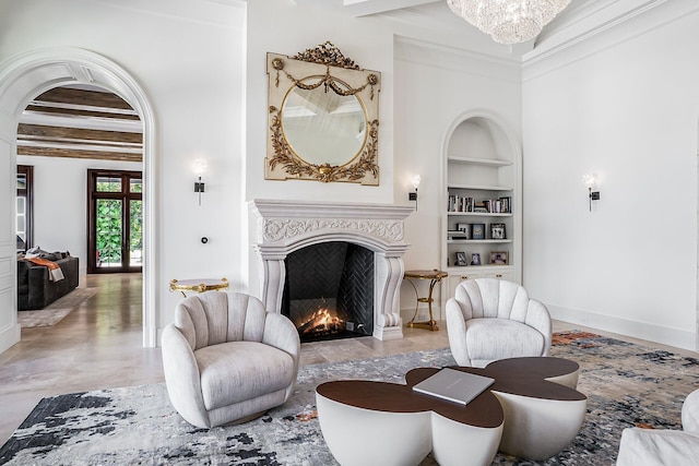 living room with beam ceiling, built in features, and an inviting chandelier