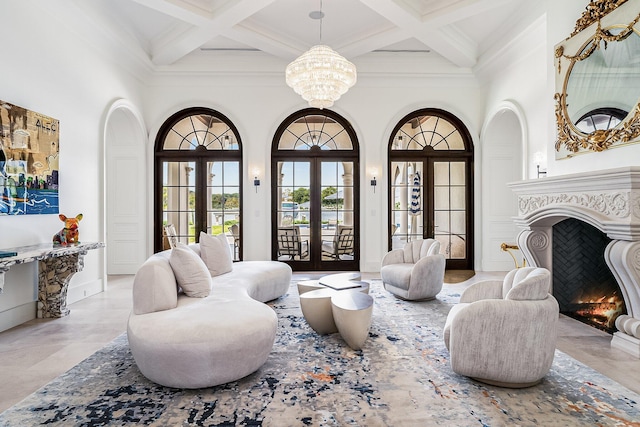 sitting room with coffered ceiling, french doors, and a high ceiling