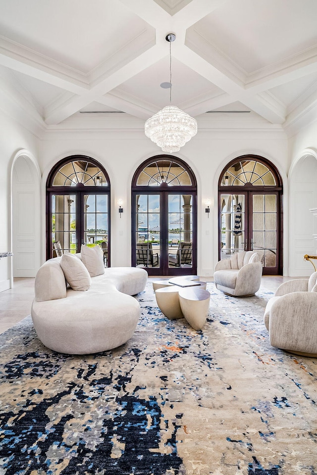 living room with an inviting chandelier, coffered ceiling, french doors, and beamed ceiling