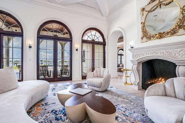 living room with crown molding, beam ceiling, and french doors