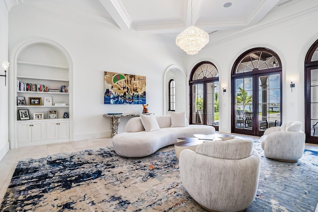 tiled living room featuring ornamental molding, a notable chandelier, built in shelves, beam ceiling, and french doors