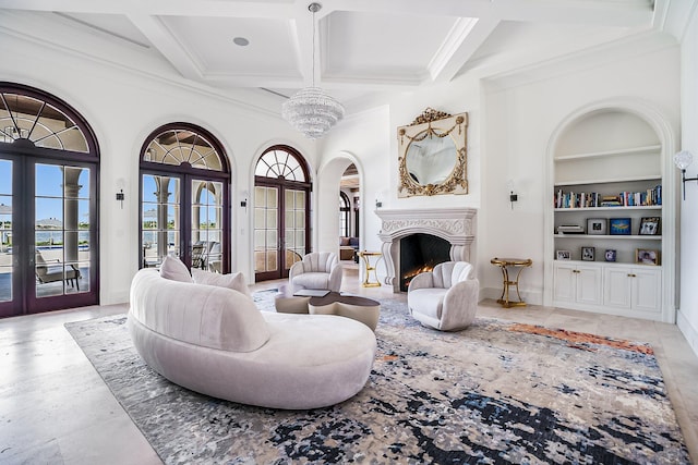 living room with coffered ceiling, built in shelves, french doors, and beamed ceiling