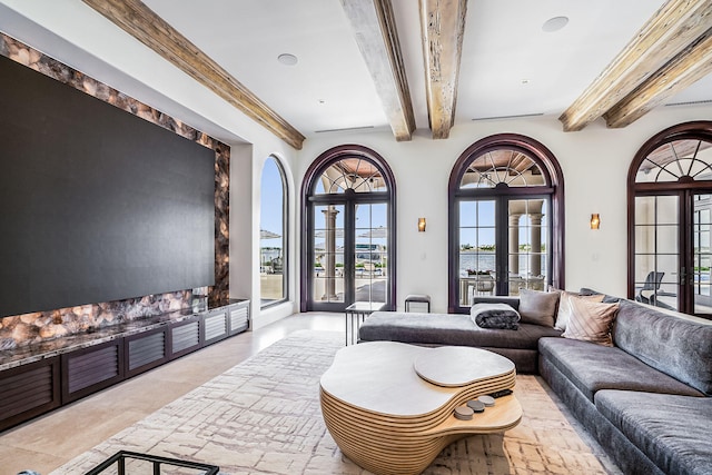 living room with beam ceiling and french doors