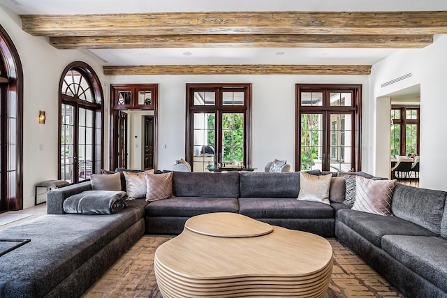 living room with french doors and beamed ceiling