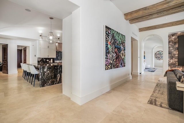 hall with vaulted ceiling with beams