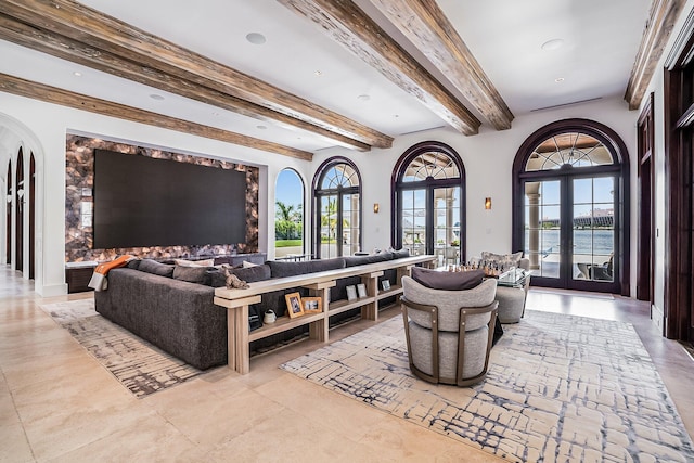 living room featuring beam ceiling, french doors, and a water view