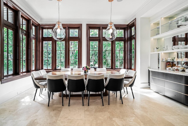 dining room with crown molding and built in features