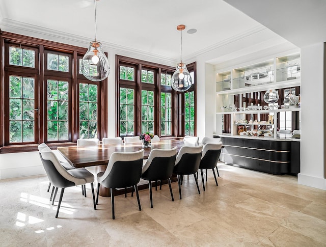 dining space featuring crown molding and built in features