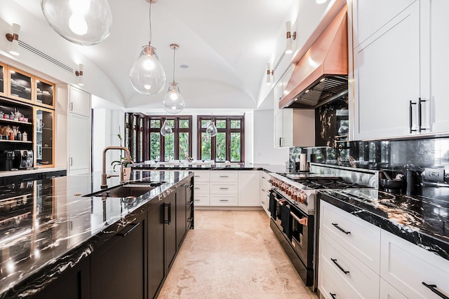 kitchen featuring premium range hood, white cabinetry, sink, hanging light fixtures, and double oven range