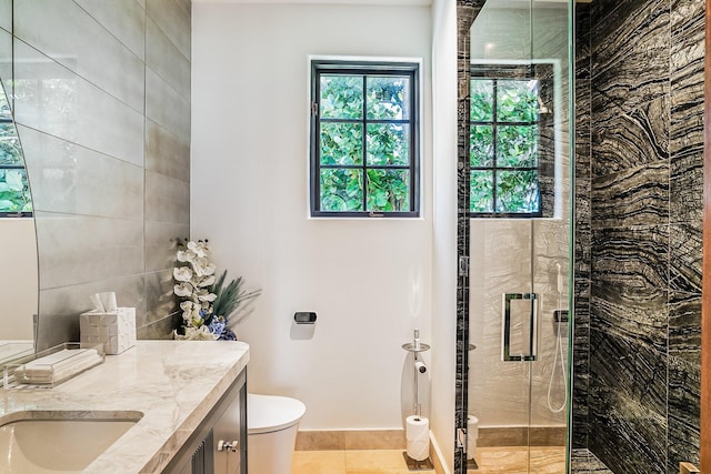 bathroom with walk in shower, vanity, and toilet