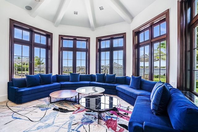 living room with lofted ceiling with beams and a wealth of natural light