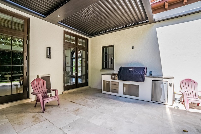 view of patio with french doors, area for grilling, and grilling area