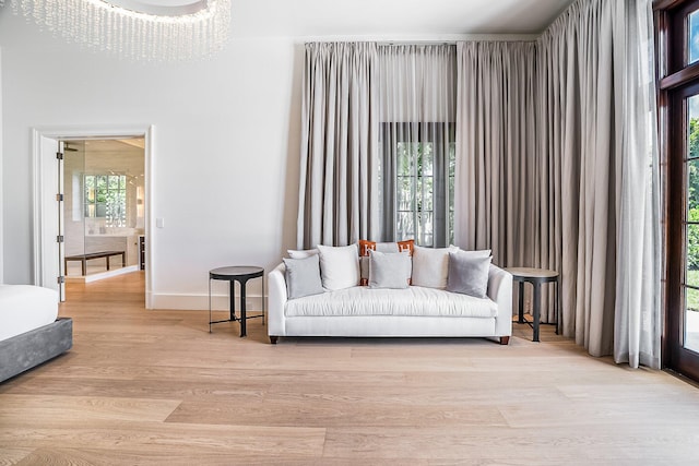 living room featuring a notable chandelier and light hardwood / wood-style flooring