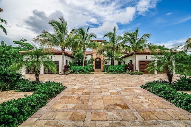 mediterranean / spanish house featuring a garage