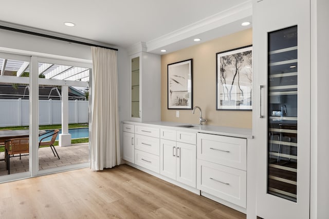 bathroom with vanity, wine cooler, and wood-type flooring