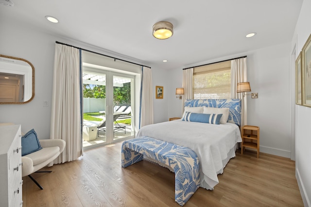 bedroom featuring access to exterior and light wood-type flooring