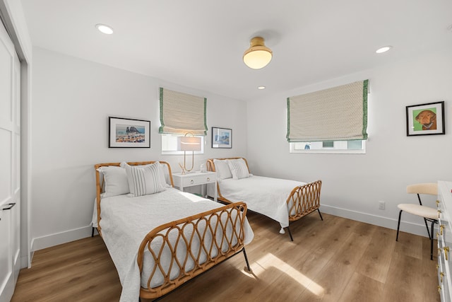 bedroom featuring multiple windows and light wood-type flooring