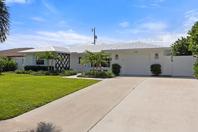 ranch-style house featuring a front yard and a garage