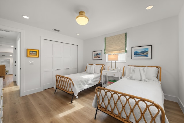 bedroom featuring light hardwood / wood-style floors and a closet