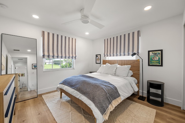 bedroom with light hardwood / wood-style flooring and ceiling fan