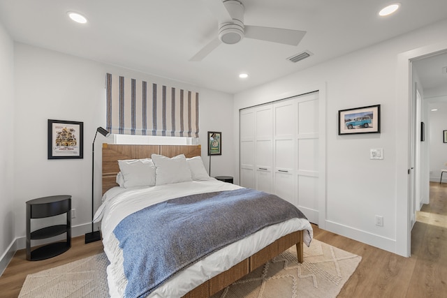 bedroom featuring light hardwood / wood-style flooring, a closet, and ceiling fan