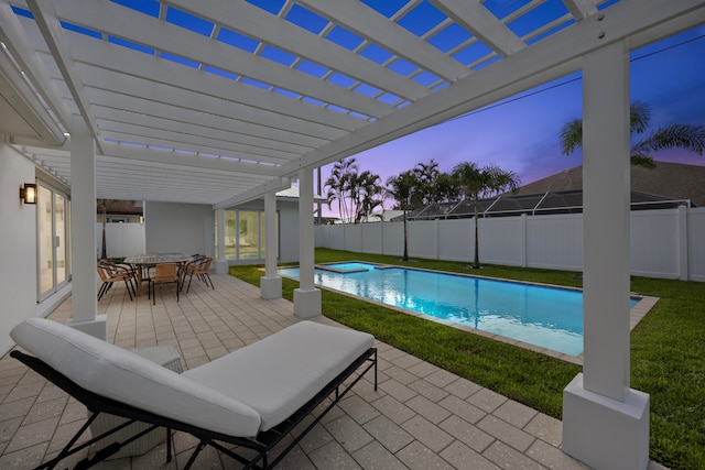 pool at dusk featuring a patio, a yard, and a pergola