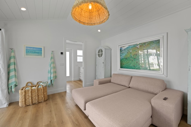 living room featuring light hardwood / wood-style floors, lofted ceiling, and wooden ceiling