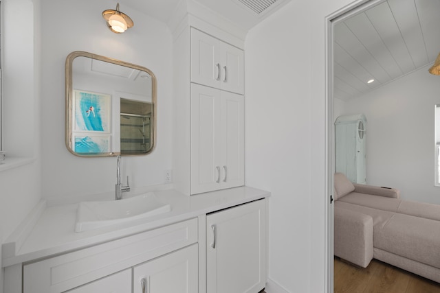 bathroom featuring vanity, an enclosed shower, and hardwood / wood-style floors